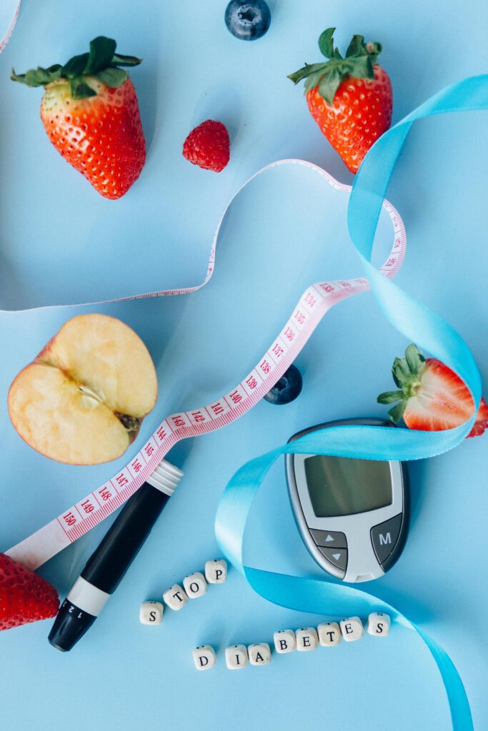 Blood glucose monitor and fresh whole fruits representing a natural approach to stopping type 2 diabetes through water fasting